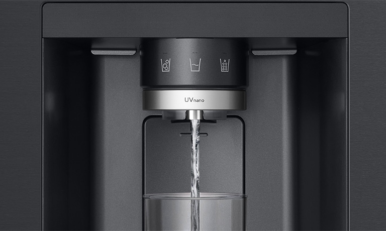 The water is coming out of the dispenser in the black refrigerator.