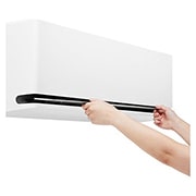 LG Premium DUALCOOL AI värmepump 3,5 kW, Hands opening the lower vane of an LG air conditioner for cleaning or maintenance, NH09SP2, thumbnail 15