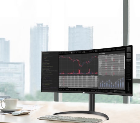 LG UltraWide Monitor som viser finansielle datadashbord og diagrammer på en buet bred skjerm, og fremhever en smidig arbeidsflyt med 100 Hz oppdateringsfrekvens i et moderne kontormiljø.