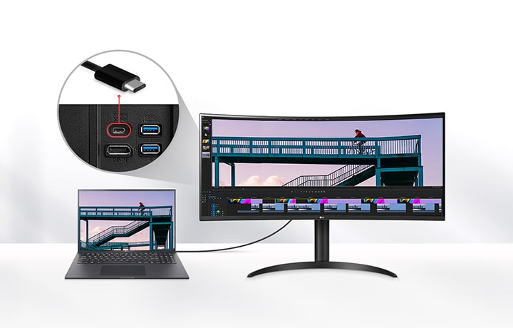 LG UltraWide-skjerm koblet til en bærbar PC via en USB-C-kabel, som viser et videoredigeringsprosjekt med en syklist på en bro, med et nærbilde av USB-C-porten og fremheving av 96 W strømleveringskapasitet.