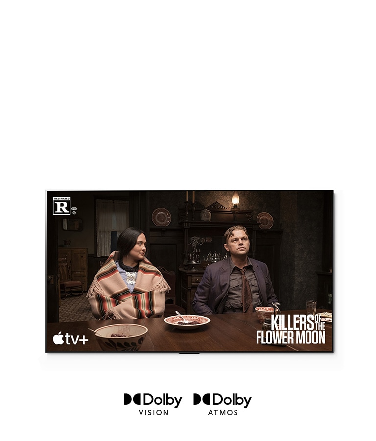 Et bilde av en mann og en kvinne som sitter sammen ved bordet, som er en scene fra filmen «Killers of the Flower Moon».