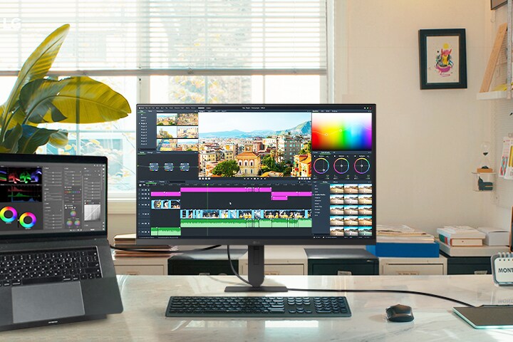 LG UHD 4K-skjermens fremhevede funksjoner viser et dynamisk arbeidsområde med en bærbar datamaskin og skjerm, perfekt for videoredigering og kreative prosjekter med imponerende visuelle uttrykk. 