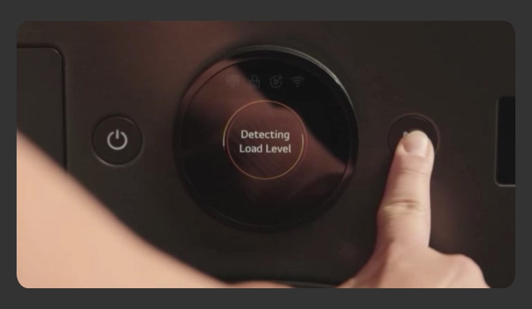 A close-up image of a dryer control panel as a finger presses an operation button on the right.