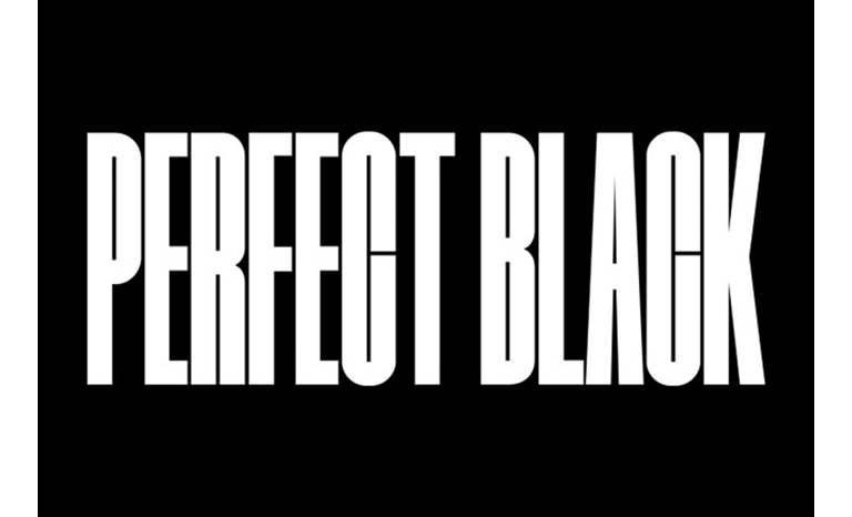 The words 'PERFECT BLACK' in white on a black background. A well-lit rocky mountain range appears in front, then moves upwards to reveal the landscape below as the words 'PERFECT BLACK' fade away.