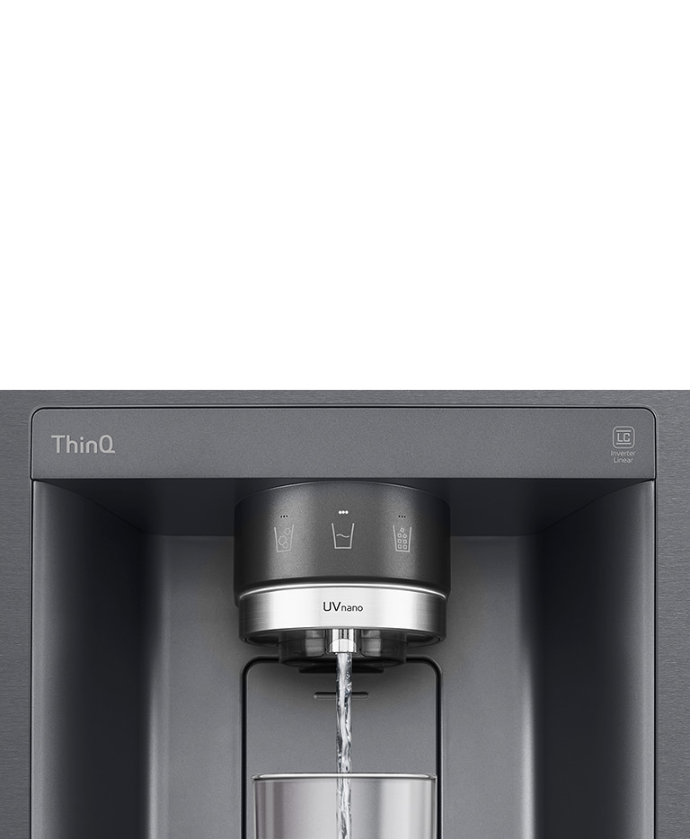 A video starts zoomed in on the water dispenser. The exterior of the refrigerator goes clear and now the interior of the door and mechanical parts of the dispenser nozzle can be seen. The video zooms in further to show the water droplets as they fall through the UVnano part of the nozzle which reduces the bacteria. The view zooms back out to see the exterior of the refrigerator again as water is being dispensed into a glass.