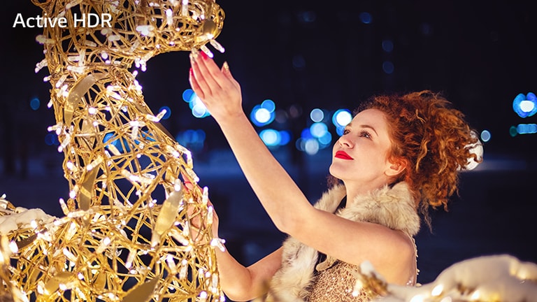 This card describes the Active HDR. It is a movie-like image of a woman touching a shining sculpture.