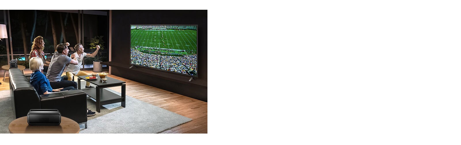 People watching sports game on TV in the living room with Bluetooth rear speakers.
