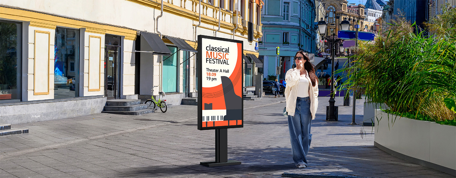 A display is installed on the street, and a woman is looking at a vivid-quality advertisement on the screen.