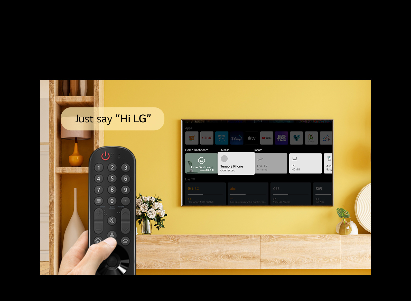 Someone is holding a TV remote in front of TV screen. In a speech bubble it says “Just say Hi LG”.