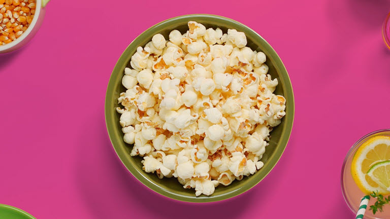The animation shows that a bowl of popcorn is being cooked faster by  LG NeoChef™ than the other one being cooked with conventional microwave oven.