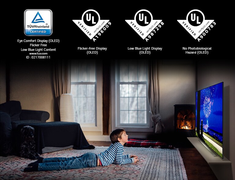 "This is the card describing the ""Eye Comfort Display"". This is a scene of a boy watching TV in a prone position. Four logos have been placed for ""Eye Comfort Display"" certification."