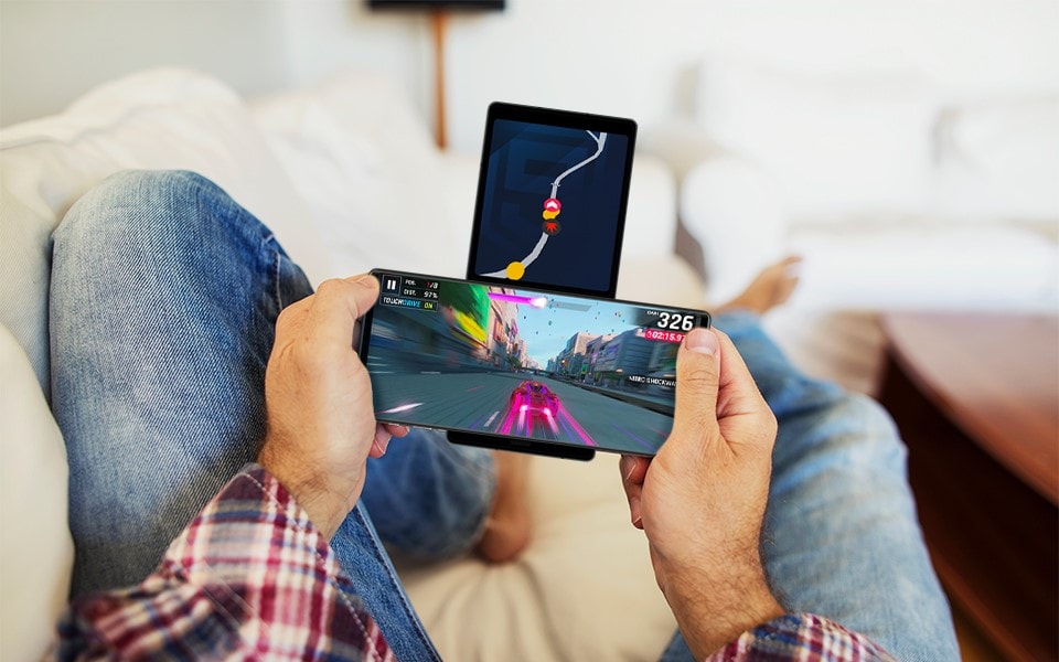 A man playing video games on his LG WING