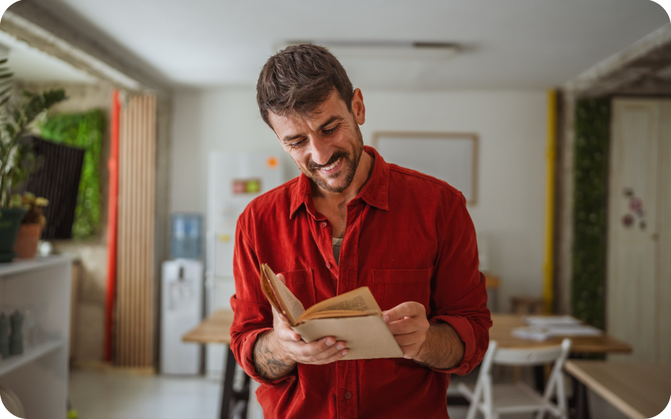 A man looking for answers in a book at work