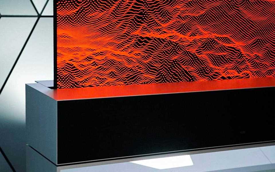 The LG SIGNATURE Rollable OLED TV rolls into its base.