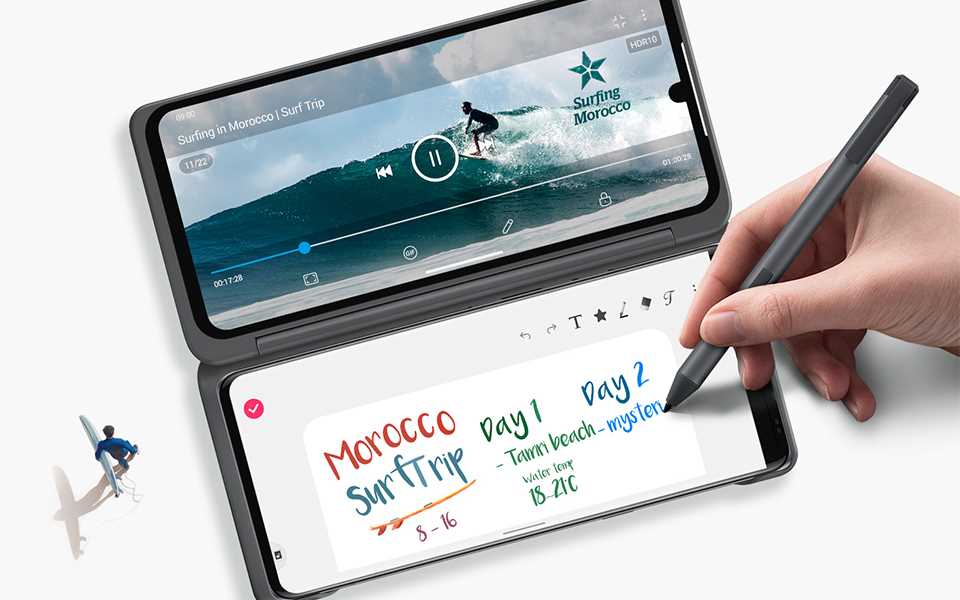 The dual screens of a LG VELVET with a video of a man surfing on one screen and on the other screen, note-taking with a stylus pen