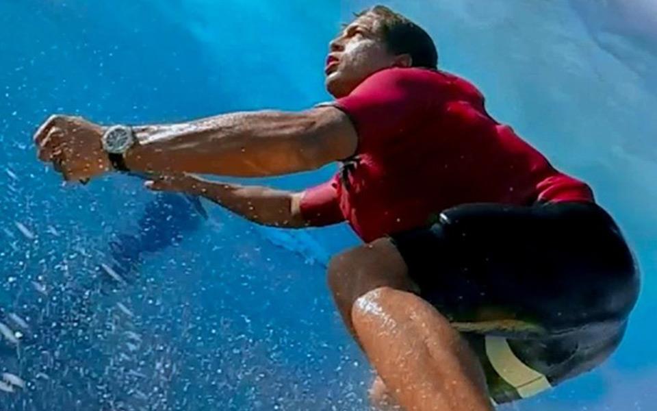 A man surfboarding in the ocean.