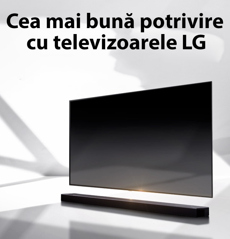 O bară de sunet și un televizor sunt plasate pe o podea albă și există o umbră care vine din exterior chiar în spate.