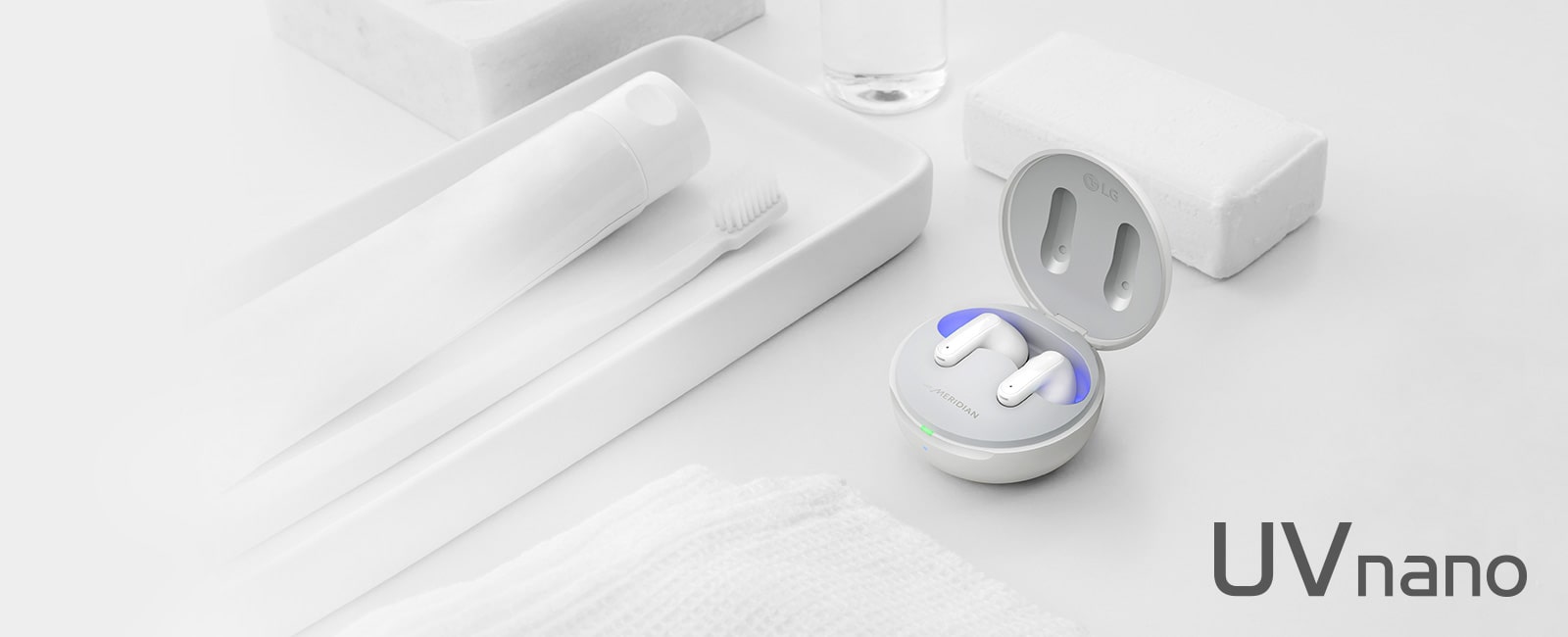 Image of TONE Free placed with objects representing cleanliness such as soap, toothbrush and toothpaste. The image contains a copy of Refresh Your BUDS and a UVnano logo.