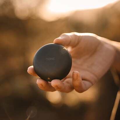 TONE FRee White's cradle is open and only the right earbud is out