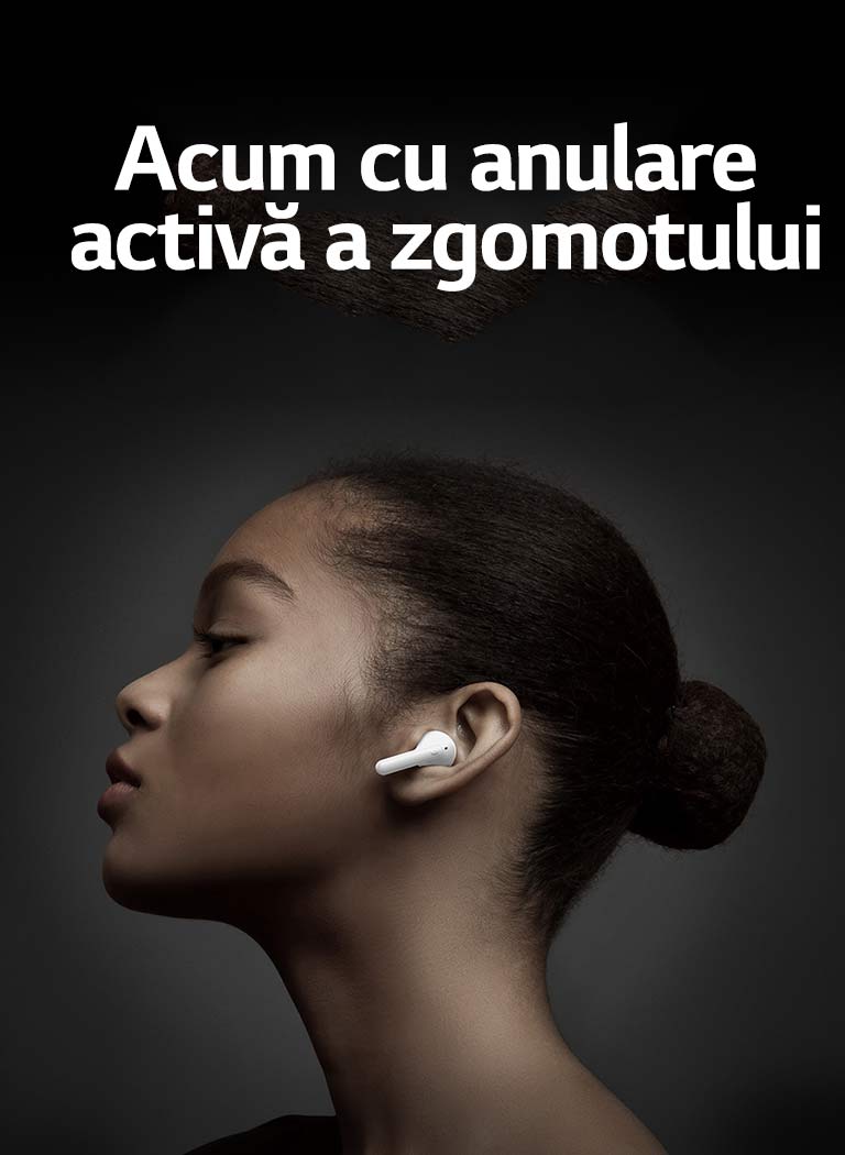 Side view of woman holding LG TONE Free against a dark background.