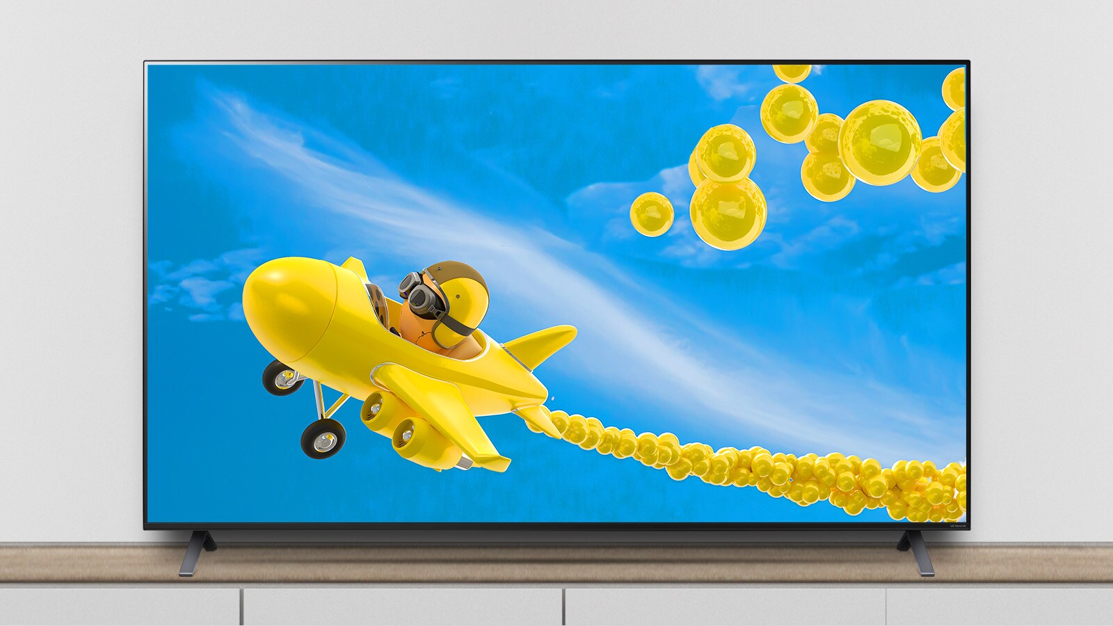 Televizorul se află pe suport și ecranul redă o animație a unui avion care zboară prin el.