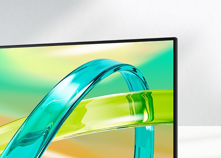 Monitorul LG FHD afișează un fundal în gradient verde și galben cu un obiect curbat translucid plutind pe ecran.