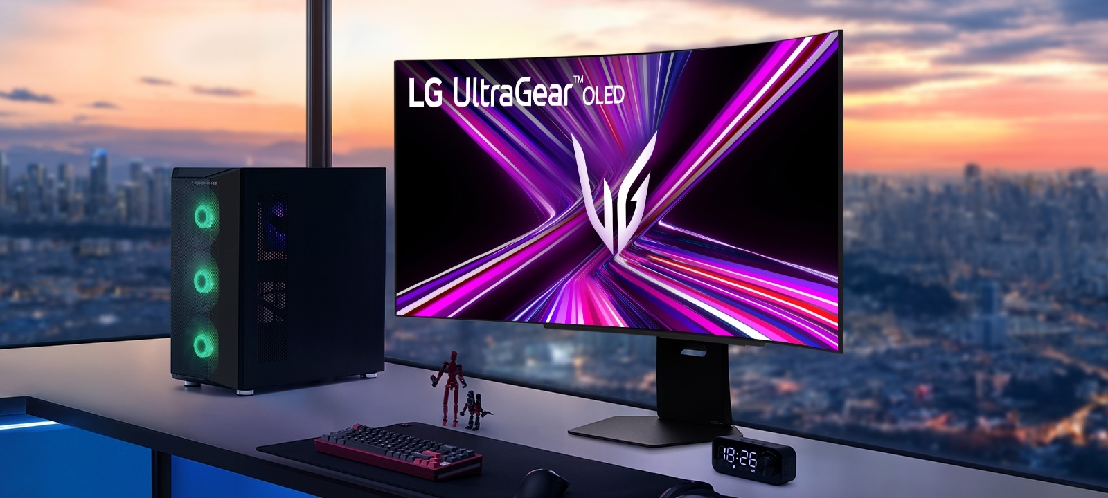 Монитор LG UltraGear OLED на бюро за игри с компютърна конфигурация, с изглед към градски пейзаж по залез слънце.