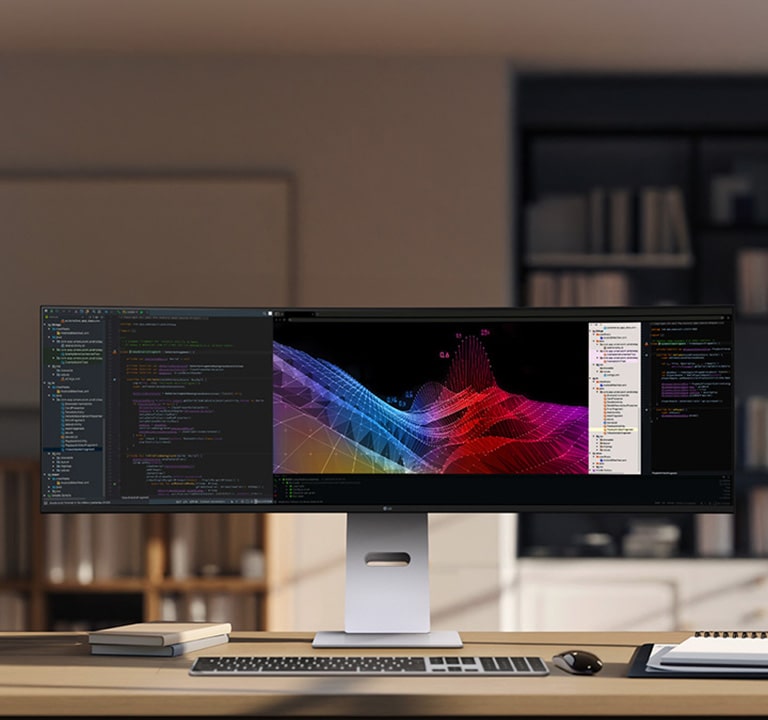 Kućna kancelarija s širokim LG monitorom na kom su kontrolne table s podacima i grafikoni, s bežičnom tastaturom i mišem.