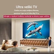 LG 85-inčni LG QNED evo AI QNED92 4K pametni televizor 2025, 'Porodica sedi na kauču okrenuta prema LG QNED TV-u postavljenom na zid iznad LG Soundbar-a, dok devojčica pokazuje na ekran koji prikazuje dva delfina. Naslov govori o tome kako je svaka radnja uzbud, 85QNED92A6A, thumbnail 9