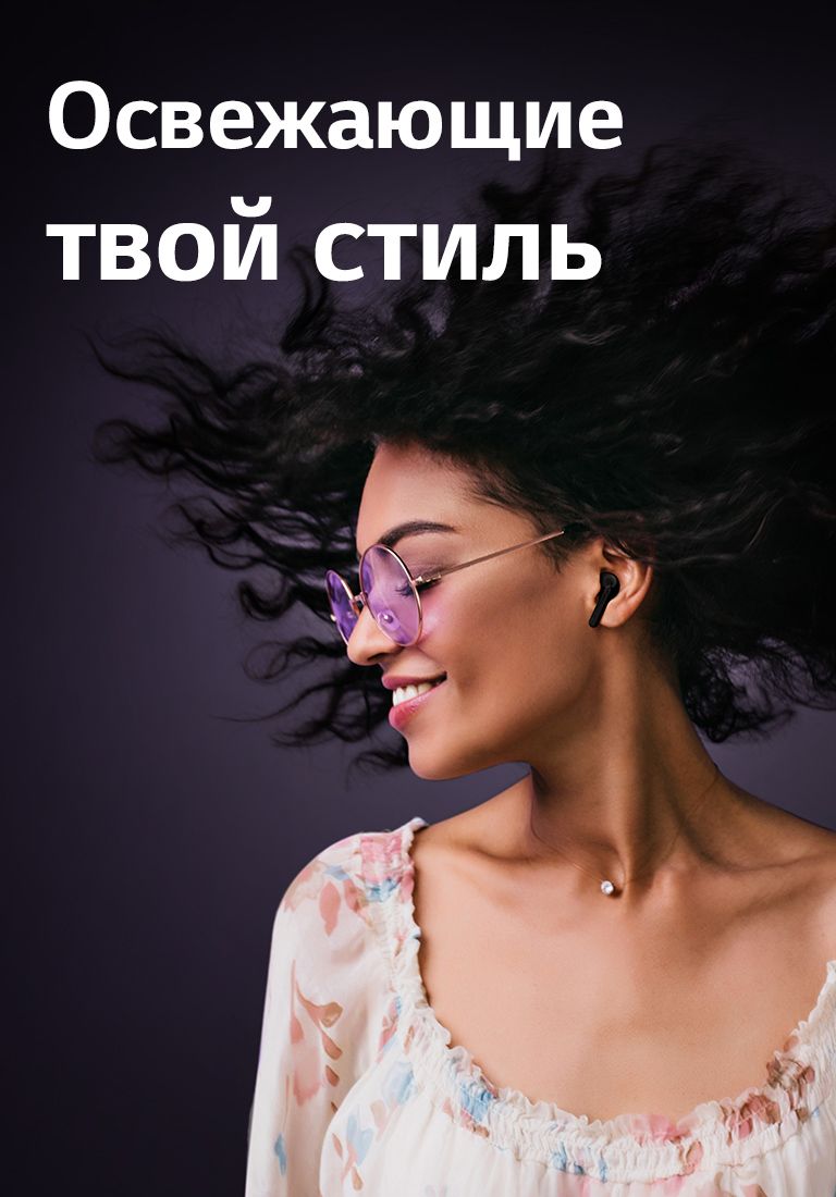 Женщина улыбается, слушая музыку с помощью TONE Free.