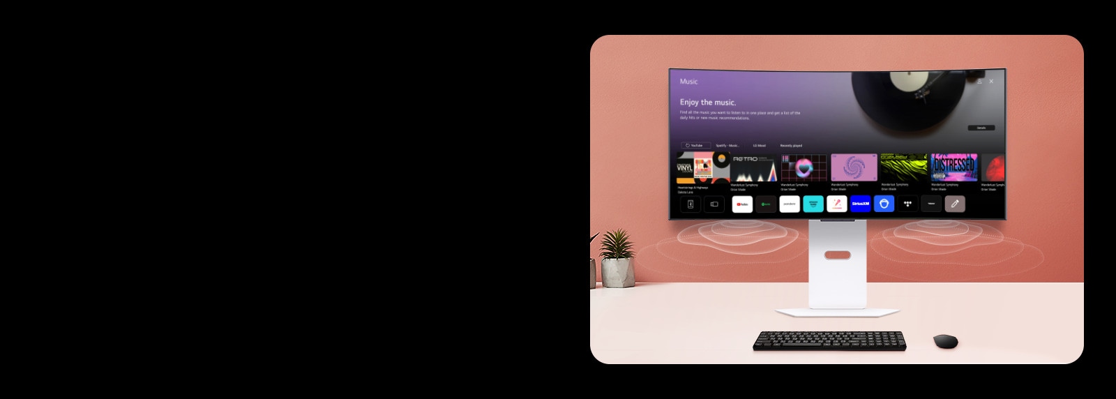 На экране смарт-монитора, размещенного на столе, изображен экран MUSIC APP.
