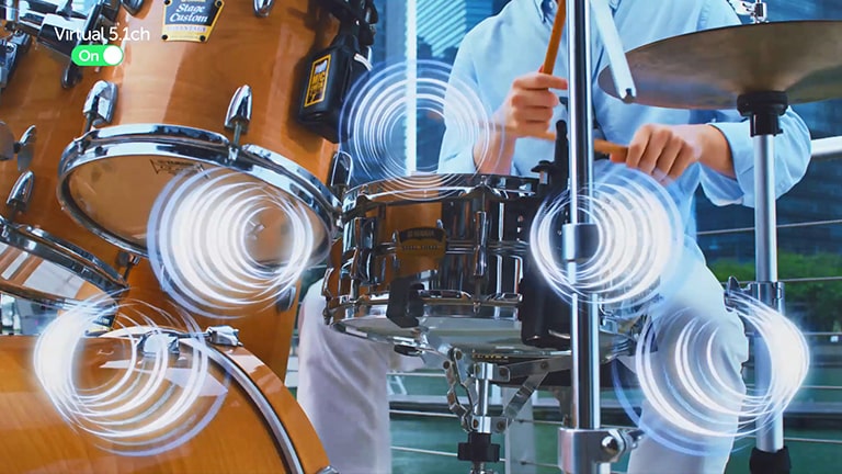 A man plays the drums. In this case, the movement of the sound emanating from the drum is simulated.