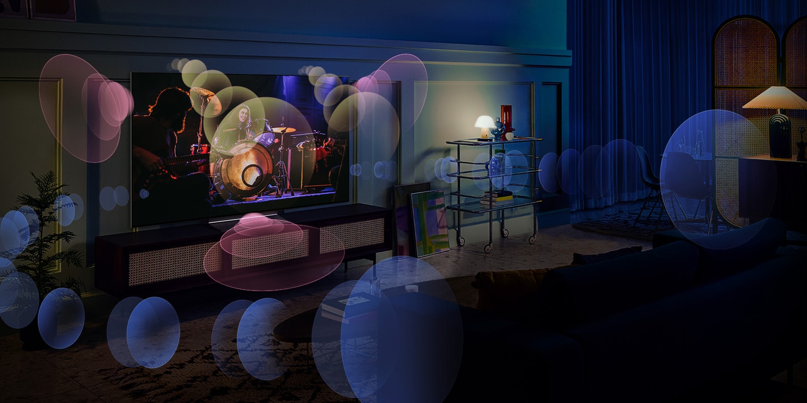 A woman sits on a couch watching a concert with bubbles depicting surround sound around her.