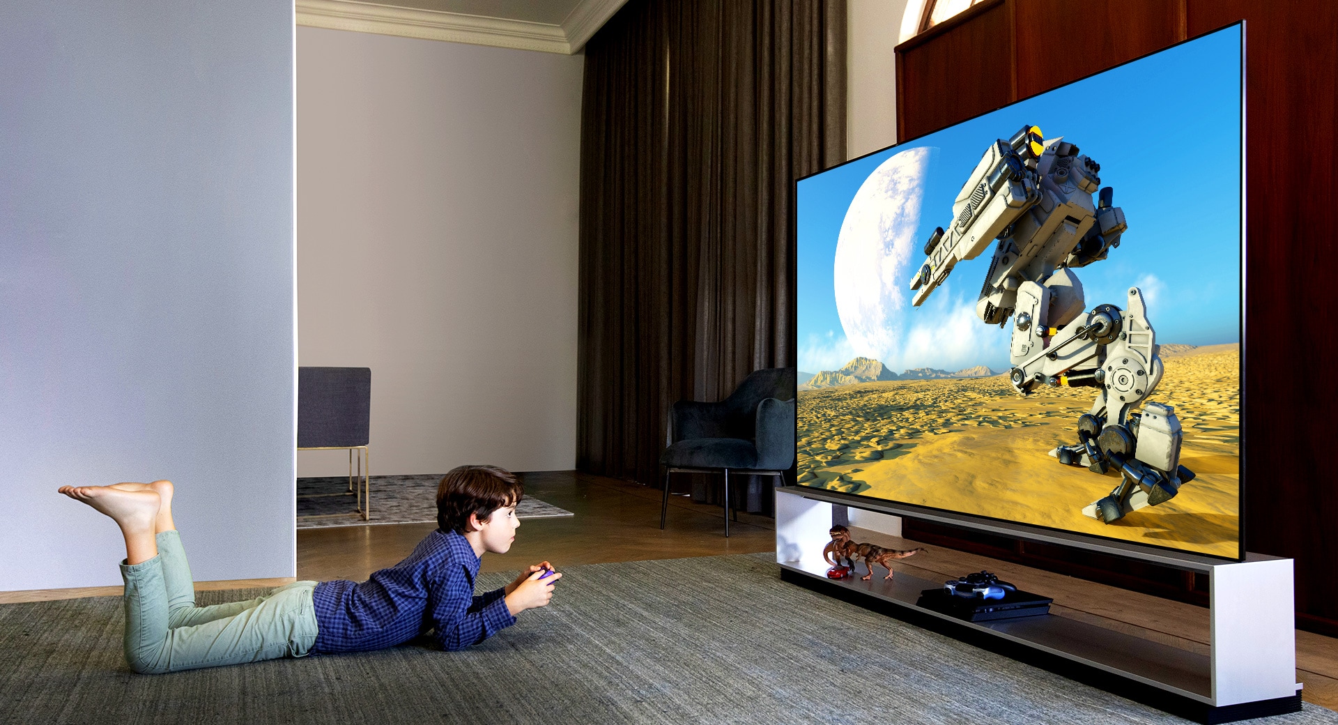 Boy lying on his stomach on the rug watching animation on a Blue Light-less TV