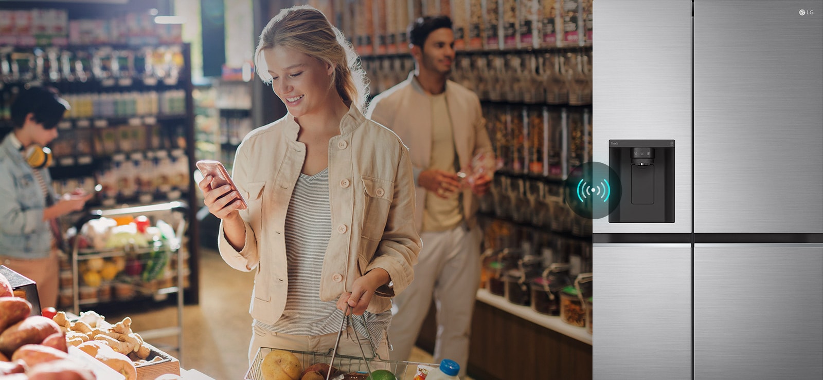 Image on the left shows a woman standing in a grocery store looking at her phone. Image on the right shows the refrigerator front view. In the center of the images is an icon to show connectivity between the phone and refrigerator.