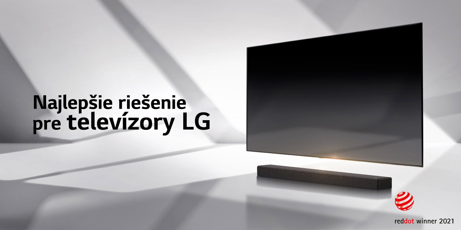 A soundbar and a TV are placed on a white floor and there is a shadow coming from outside right behind.