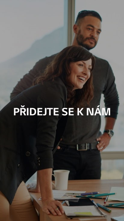 A man and a woman standing in a meeting room