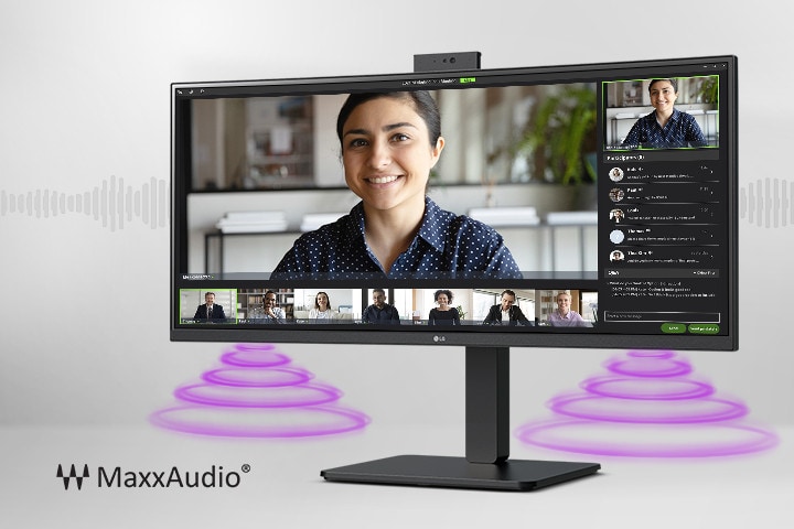 Na obrazovke monitora je zobrazená videokonferencia, zatiaľ čo vychádza zvuk z reproduktorov v spodnej časti monitora. V ľavom dolnom rohu sa zobrazuje logo MaxxAudio®.
