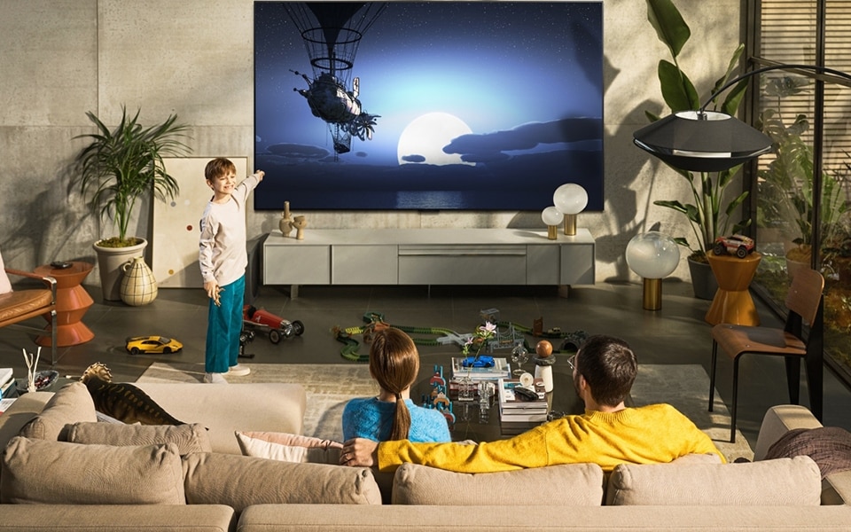 A family sits at the right distance from the TV
