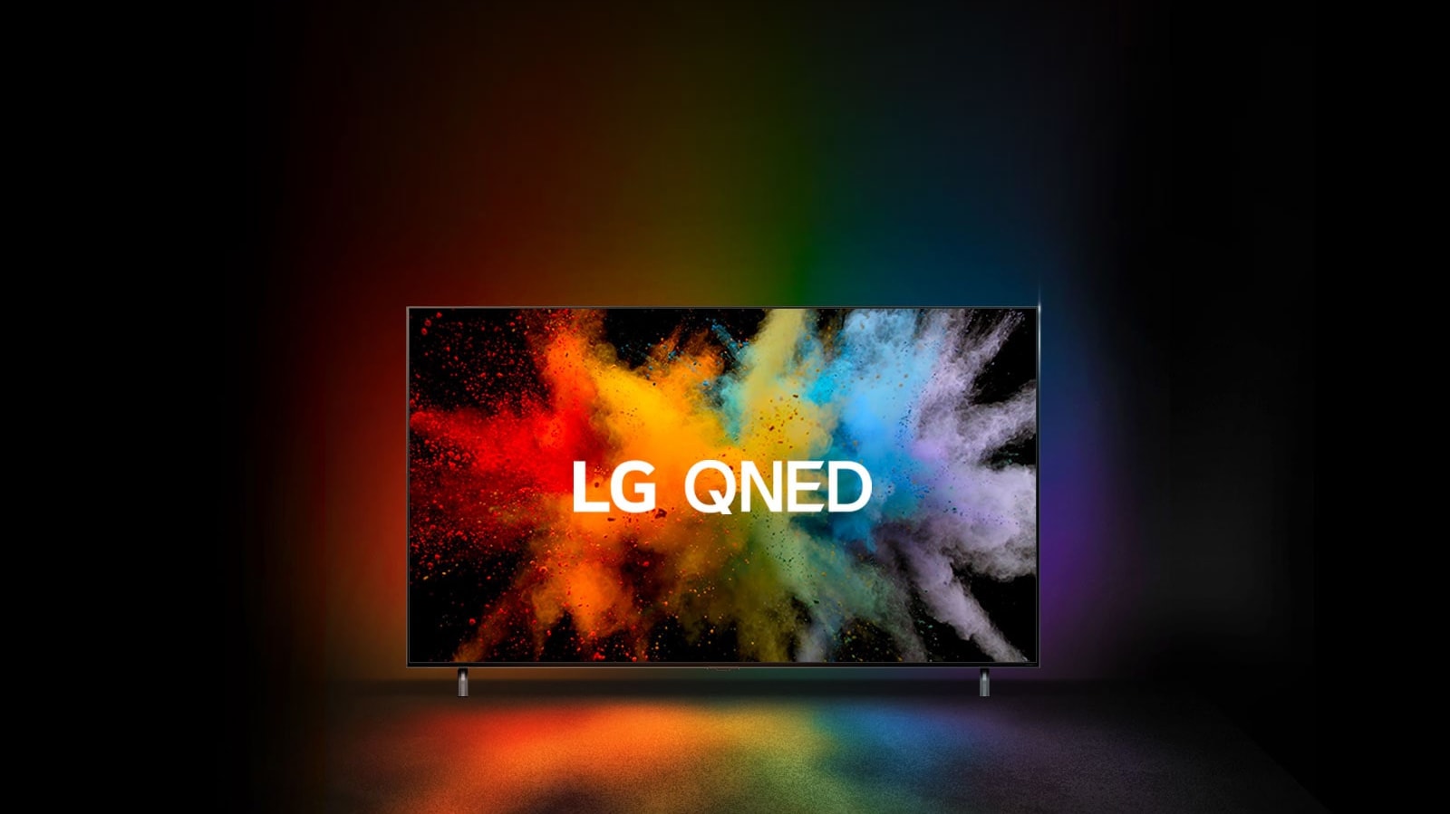 An LG QNED in a dark room. Dyed powders create an explosion of rainbow colors on the TV.