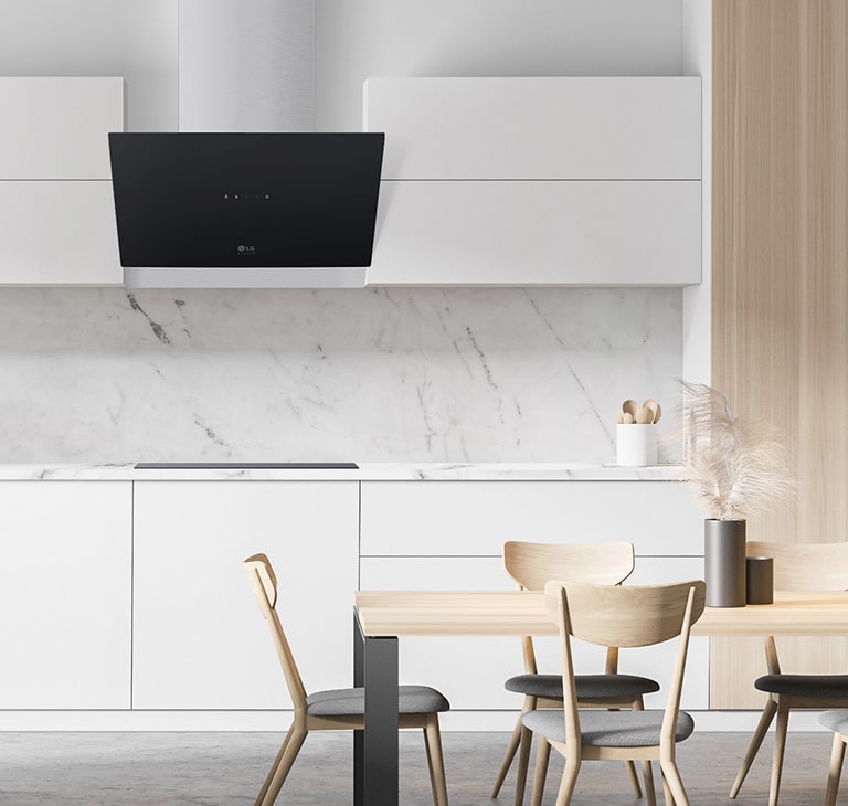 The chic black modern oven hood is installed in a modern white kitchen.