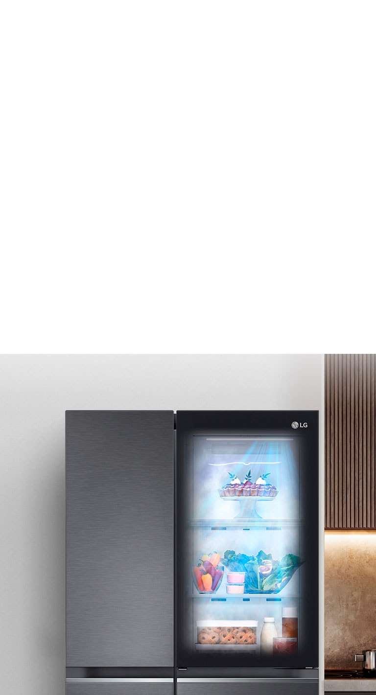 Показано холодильник в інтер'єрі кухні з підсвіченим віконцем у дверцятах, що дозволяє побачити вміст всередині на полицях. Також видно, як продукти в холодильнику обдуває свіже холодне повітря.