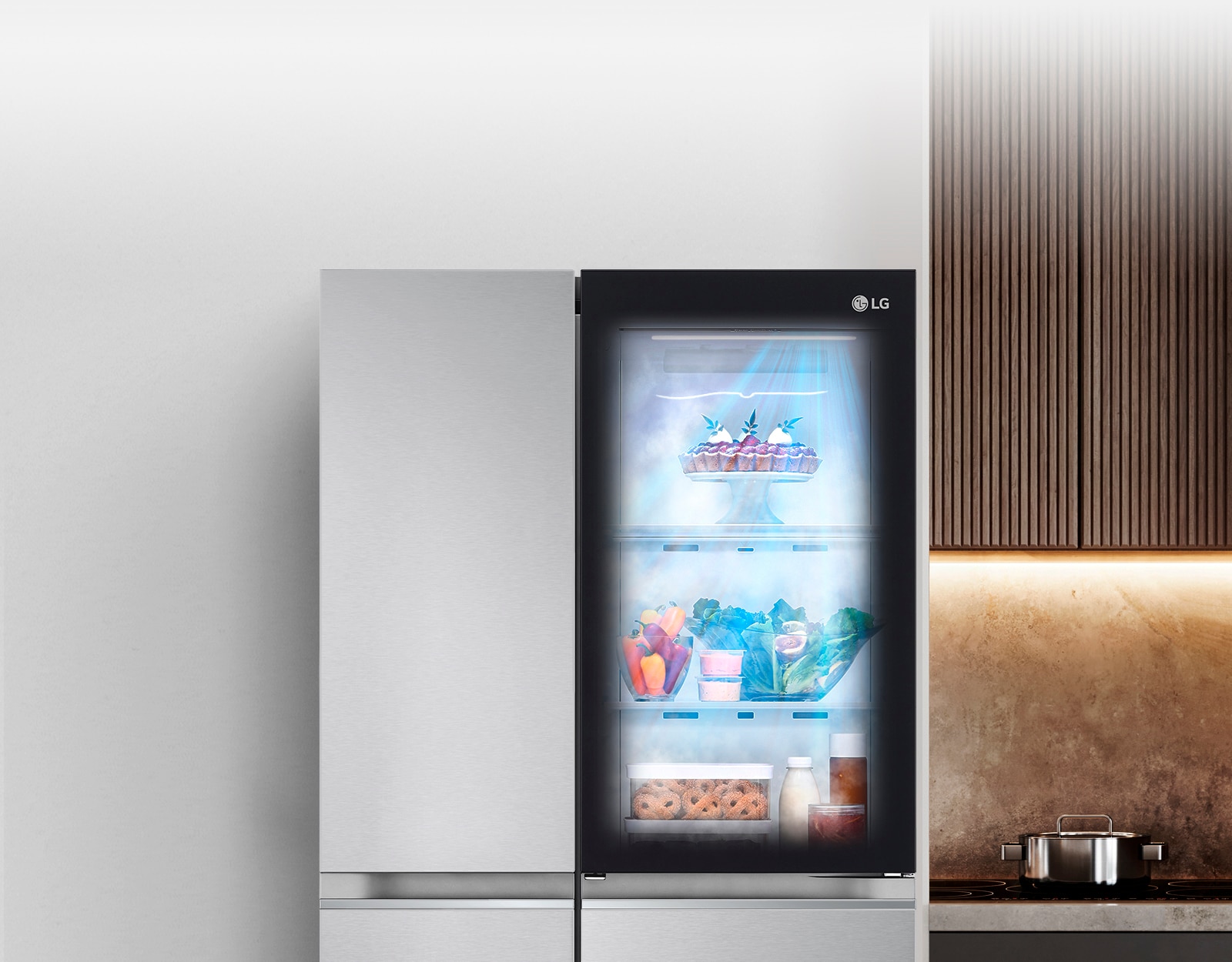 Показано холодильник в інтер'єрі кухні з підсвіченим віконцем у дверцятах, що дозволяє побачити вміст всередині на полицях. Також видно, як продукти в холодильнику обдуває свіже холодне повітря.