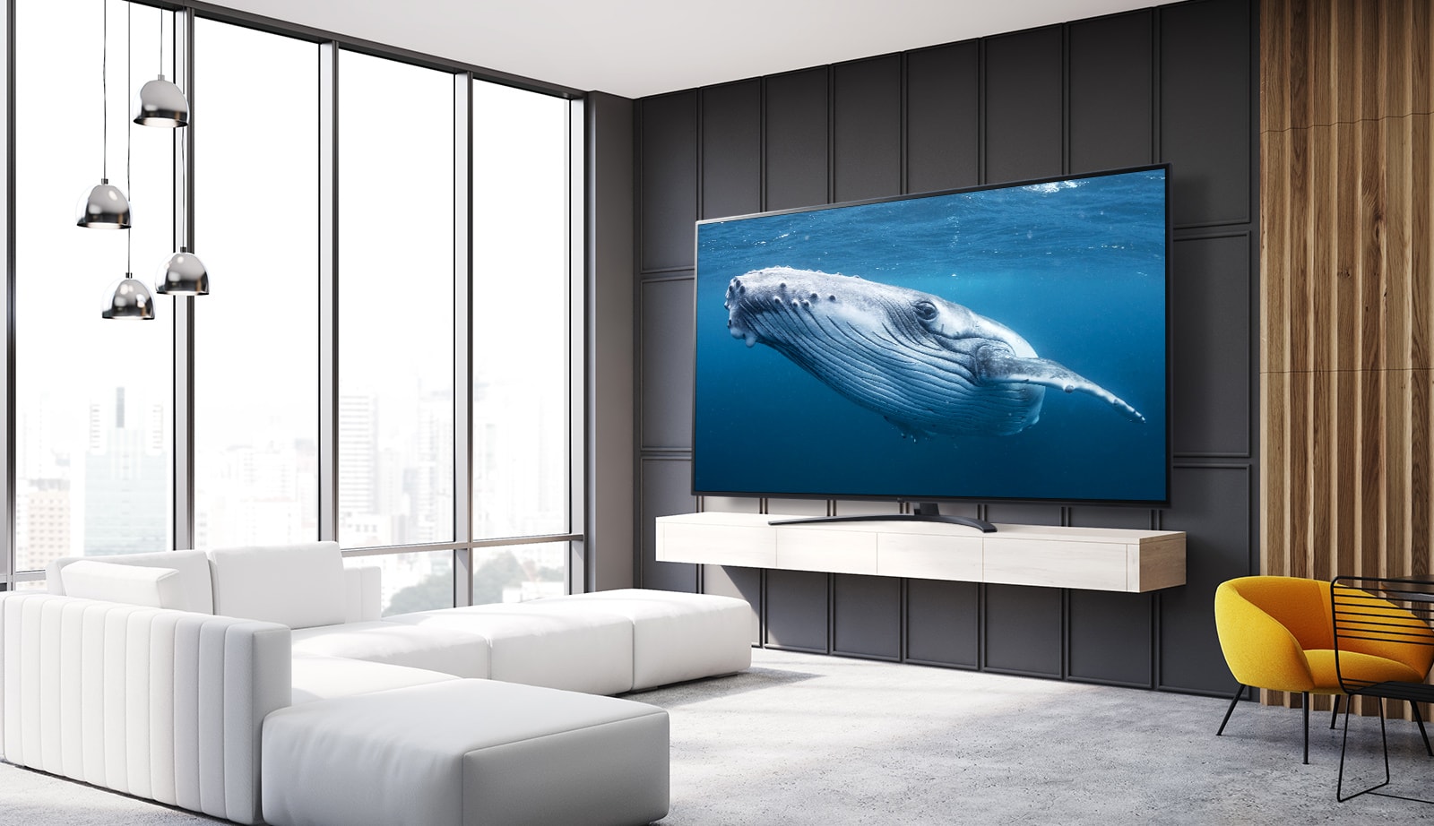 У вітальні стоїть телевізор із великим екраном, який показує зображення великого кита в морі.