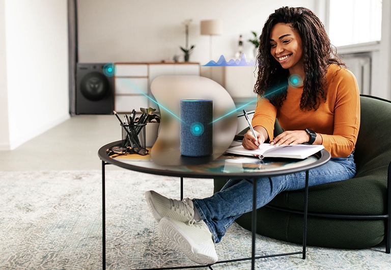 Жінка, яка керує пральною машиною з голосовим асистентом