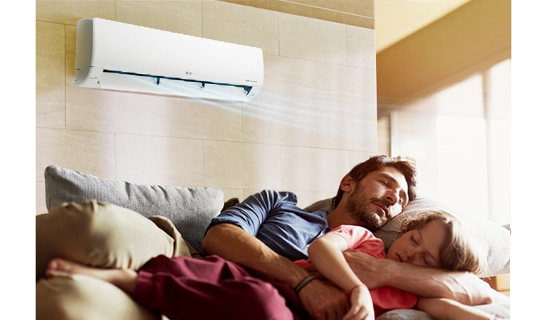 Батько з донькою сплять на дивані під кондиціонером, який випускає повітря блакитного кольору.