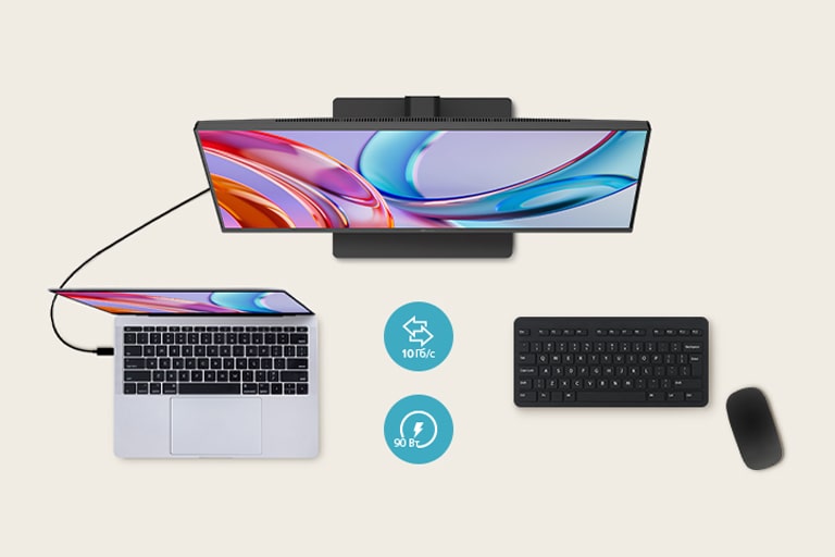 Вид зверху монітора, підключеного до ноутбука, з клавіатурою та мишею, розміщеними поруч.	