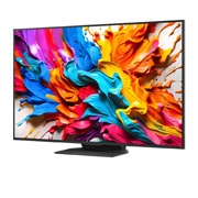 LG Телевізор LG QNED evo AI QNED9M MiniLED | 65 дюймів | 4k Smart TV | 2025, Тьмяно освітлена вітальня з ігровим екраном, зображеним на QNED9M. Приставка Zero Connect Box стоїть всередині журнального столика. У тексті йдеться про надчутливий бездротовий ігор із низькою затримк, 65QNED9MA6B, thumbnail 5
