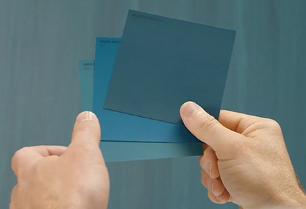 close shot of darren palmer's hands holding bluish color palette chips