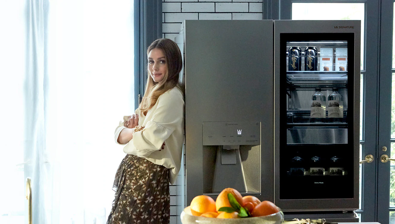 Olivia Palermo leans against the LG SIGNATURE Refrigerator.